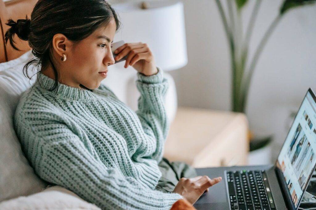 Photo by Liza Summer: https://www.pexels.com/photo/focused-young-ethnic-woman-with-credit-card-and-laptop-6348124/