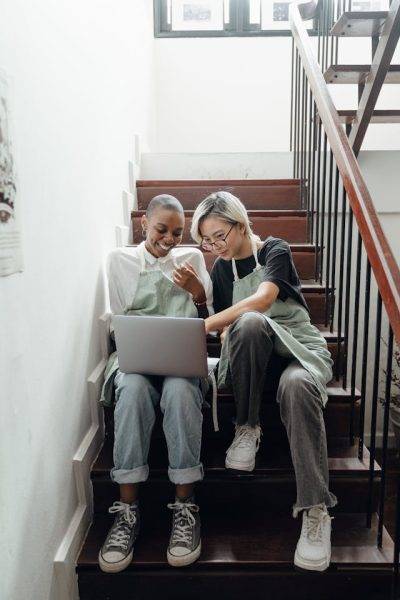 Photo by Ketut Subiyanto: https://www.pexels.com/photo/happy-young-multiethnic-baristas-watching-movie-on-laptop-sitting-on-stairs-during-break-4350202/