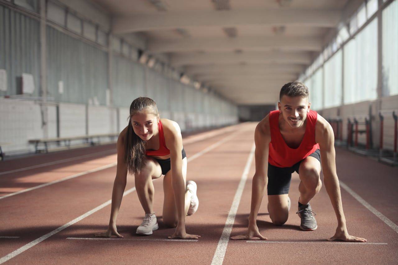 Photo by Andrea Piacquadio: https://www.pexels.com/photo/men-and-woman-in-red-tank-top-is-ready-to-run-on-track-field-3764538/