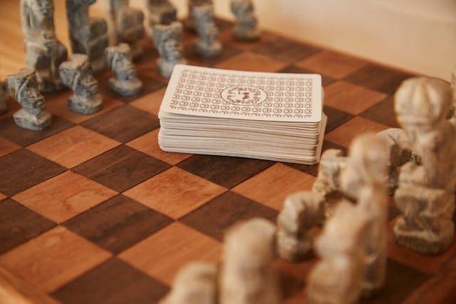 Photo by Laker : https://www.pexels.com/photo/chessboard-with-chess-pieces-and-game-of-cards-5792849/