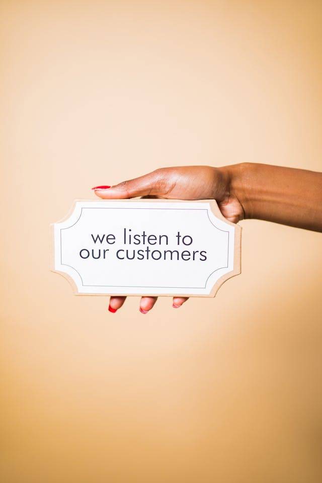 Photo by RDNE Stock project: https://www.pexels.com/photo/person-holding-a-board-with-a-text-saying-we-listen-to-our-customers-7564196/