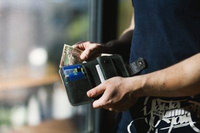 Photo by EVG Kowalievska: https://www.pexels.com/photo/photograph-of-person-holding-black-leather-wallet-with-money-1174750/